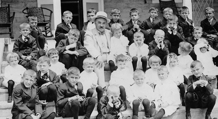 Milton Hershey and Milton Hershey School students sitting on school steps