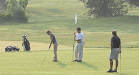 men putting on a golf course
