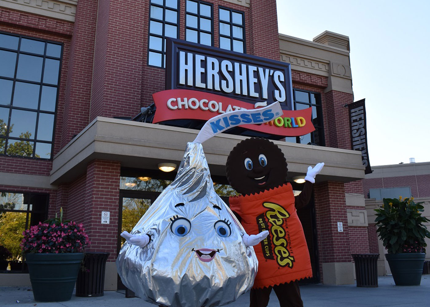 family taking a selfie in front of Hershey's Chocolate World