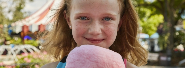 girl eating cotton candy