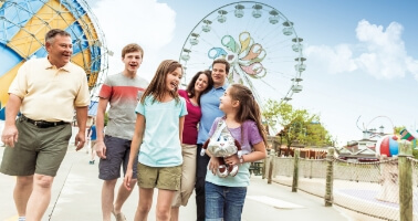 Family standing in front of roller coaster at Hersheypark