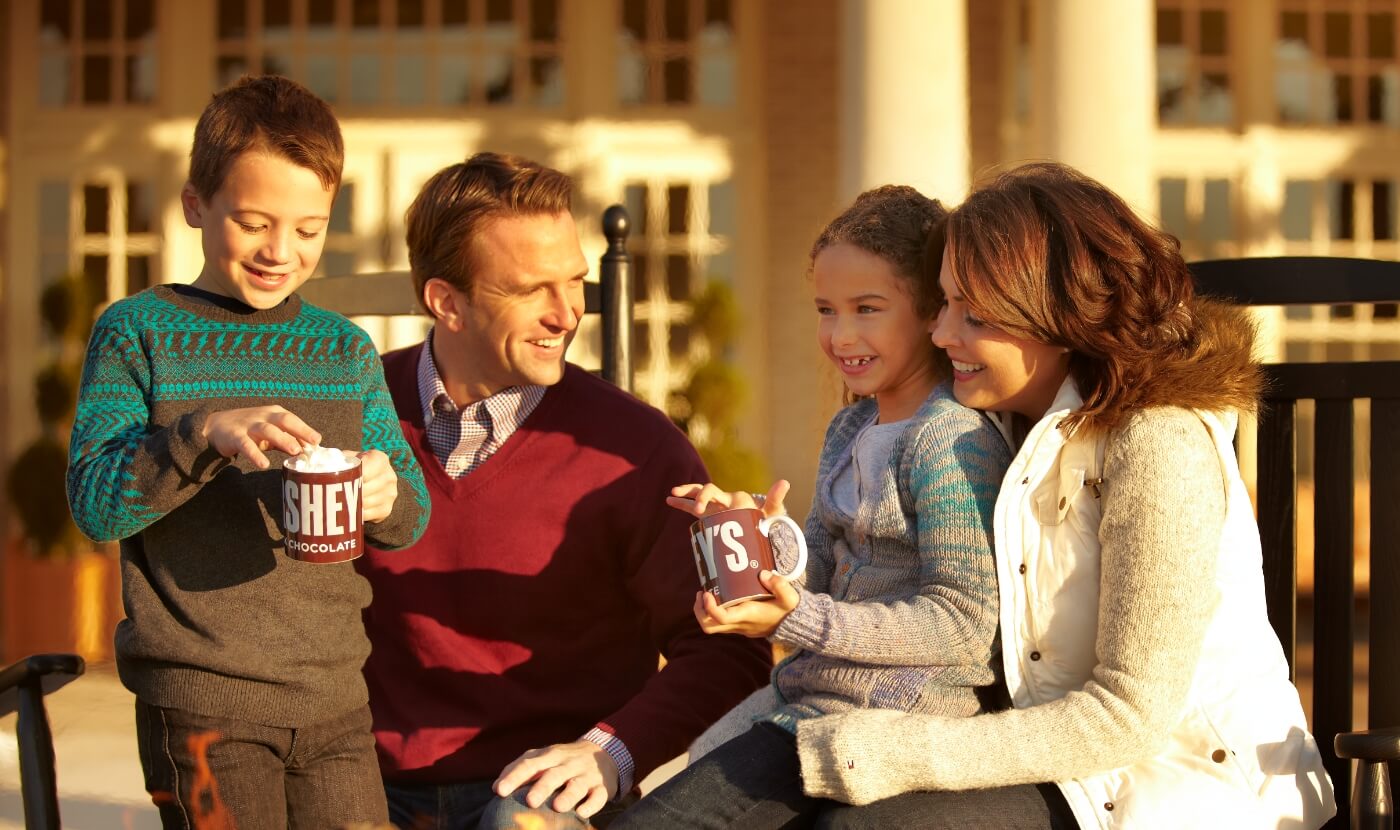 Family around firepit at The Hotel Hershey