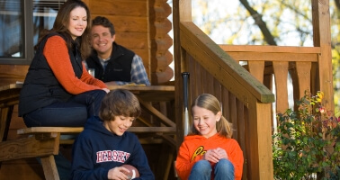Family outside of cabin at Hersheypark Camping Resort