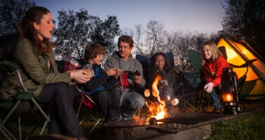 Family around campfire at Hersheypark Camping Resort