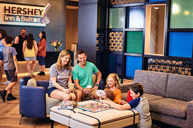 Family playing games at Hershey Inn & Suites.