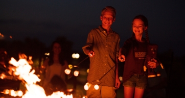 Kids roasting marshmallows on fire