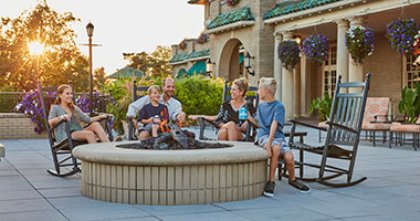 a family on the veranda in front of The Hotel Hershey