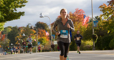 girl running in through Hersheypark participating in the Hershey 10k