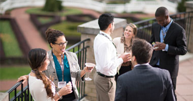 business dressed people on the back porch of The Hotel Hershey meeting space