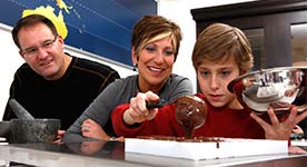 Parents with child in chocolate lab