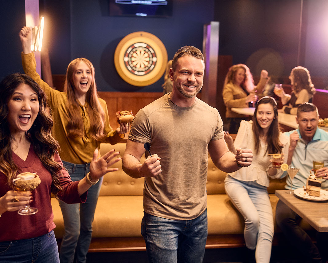 Friends playing darts